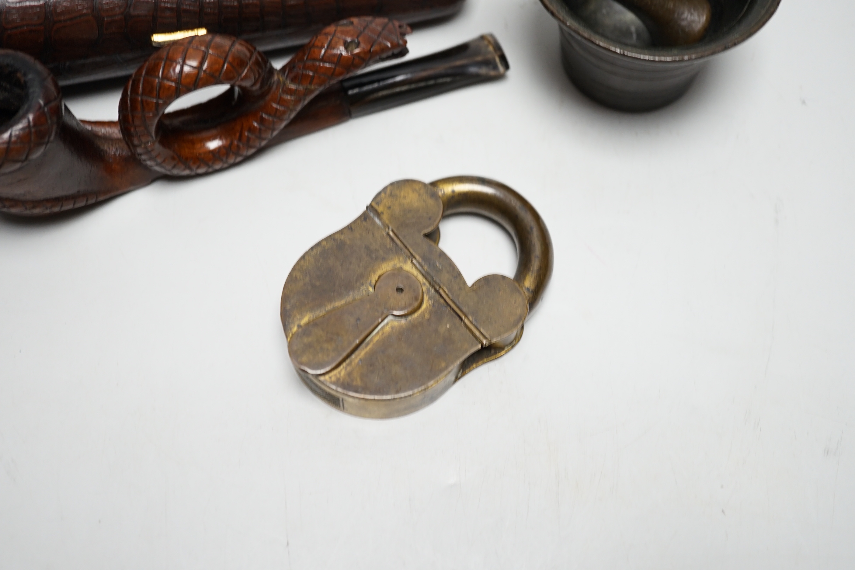 A novelty cased pipe, a miniature pestle and mortar and a novelty vesta case